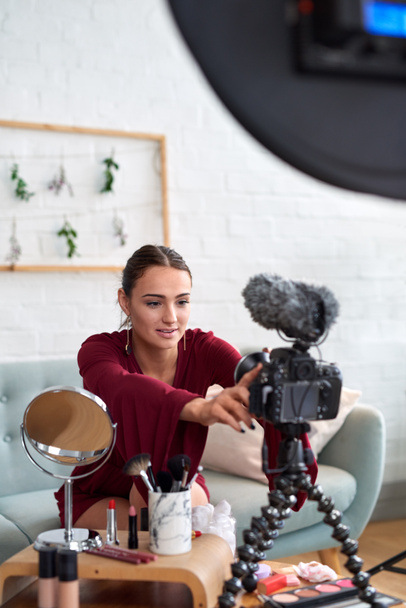 Young female vlogger adjusting her video equipment for lifestyle cosmetics online vlog - Foto, Imagem
