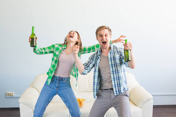 Friendship, sports, entertainment and soccer world cup - happy friends with chips and beer watching sports at home - Фото, изображение