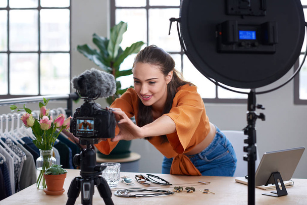 Young female vlogger adjusting video equipment   - Foto, Bild