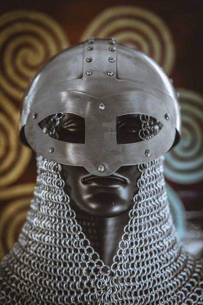 Hauberk, helmet of viking warrior with mail on coat of arms with drawings and viking symbolism, traditional art of northern Europe, conflict, struggle and war - 写真・画像