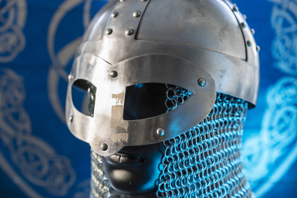 berserker, helmet of viking warrior with mail on coat of arms with drawings and viking symbolism, traditional art of northern Europe, conflict, struggle and war - Φωτογραφία, εικόνα