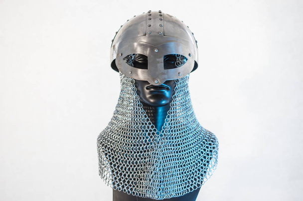 Viking helmet with chain mail in a black mannequin on white background. clothes for the viking war - Fotó, kép