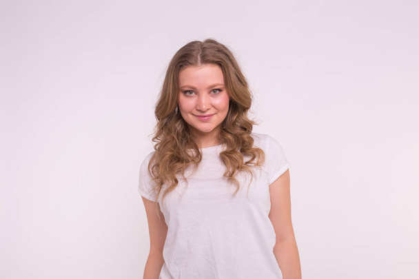 Fashion, style and people concept - pretty young woman dressed in white shirt over white background - Fotoğraf, Görsel