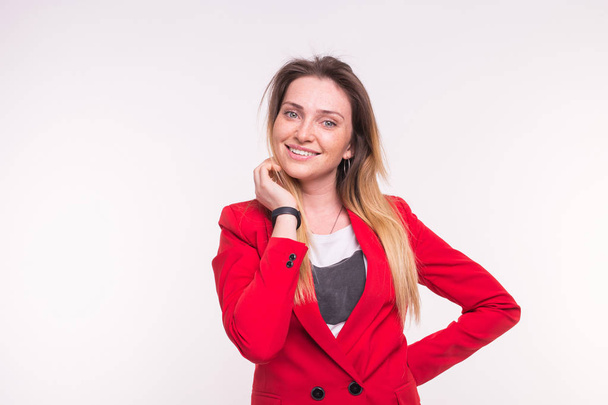 Portrait of fashionable young white woman posing in red suit in studio. - Foto, Imagen