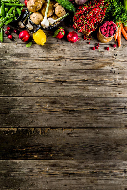 Fresh summer fruit, berry and vegetables on wooden rustic background copy space above - Photo, Image