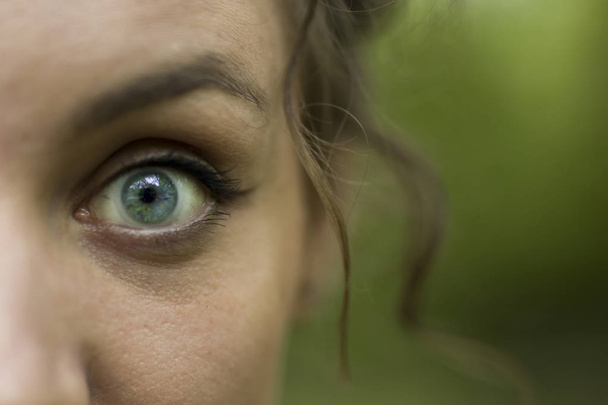 Крупный план глаз молодой женщины на открытом воздухе
 - Фото, изображение