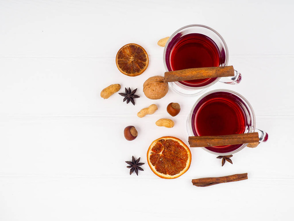 glass of mulled wine and spices on white background - Fotó, kép