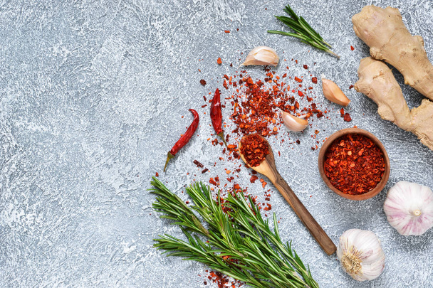 Ingredients for marinating meat, spices: rosemary, ginger, chili, garlic on a concrete, gray background. - Φωτογραφία, εικόνα