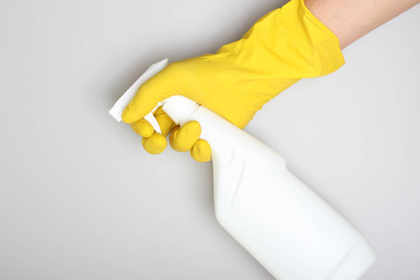 hand yellow glove and white bottle sprayer - Foto, immagini
