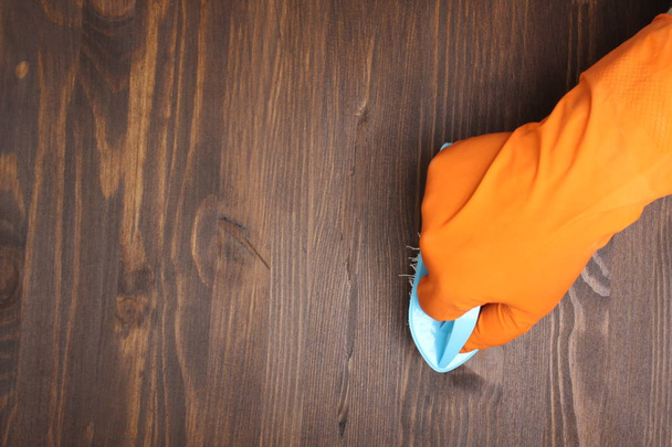 orange glove and brush on a wooden background - Foto, Imagem