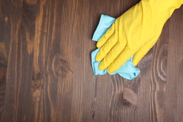 yellow glove and rag on a wooden background - Foto, immagini