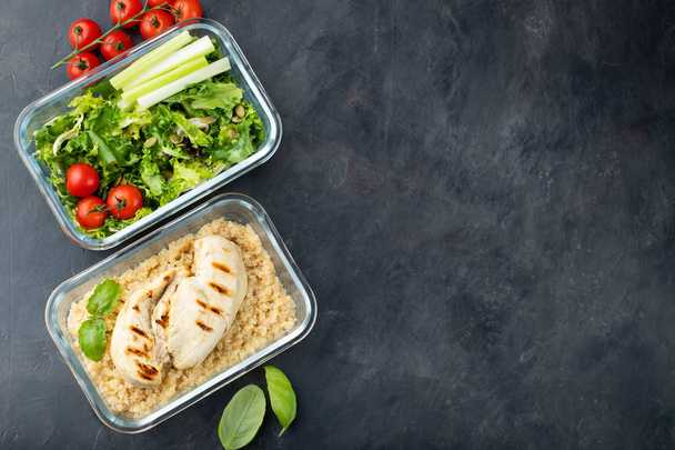 Healthy meal prep containers with quinoa, chicken breast and green salad overhead shot with copy space. Top view. Flat lay. - Photo, Image