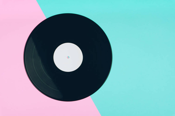 top view of a long play vinyl record or LP on the pink and blue background - Photo, Image