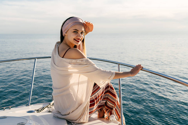 a luxurious stylish woman enjoys a vacation in the Caribbean sea, sails to the island - Фото, зображення