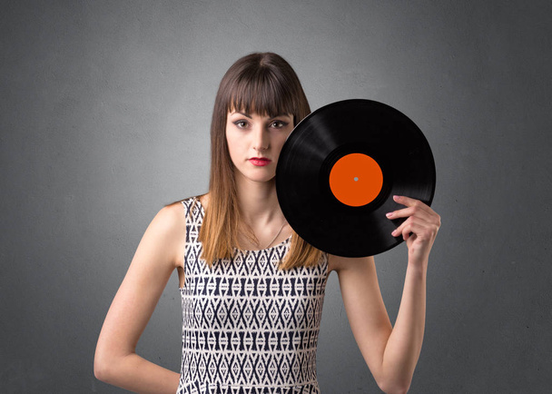 Lady holding vinyl record - Foto, afbeelding