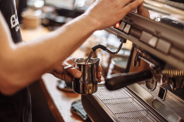 cropped side view photo of a coffee shop man preparing espresso - Фото, изображение