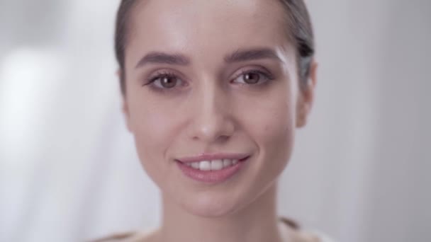 Womans Face Care. Smiling Female Touching Skin On Face  - Materiał filmowy, wideo