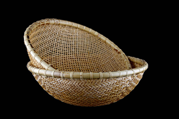 Hand made bamboo baskets from Sarawak Borneo isolated on a black background - Photo, Image