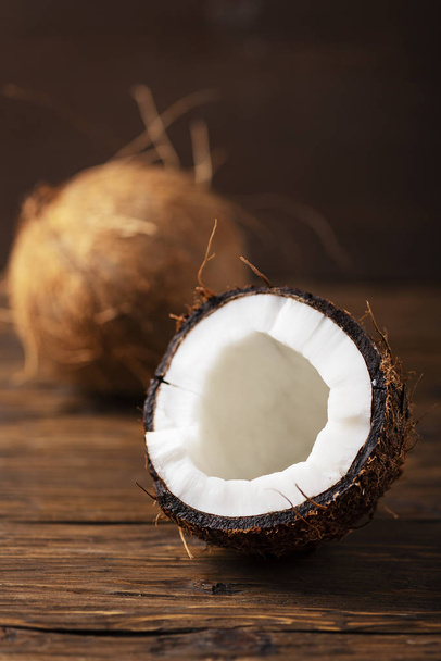 fresh coconut on wooden table, selective focus - 写真・画像