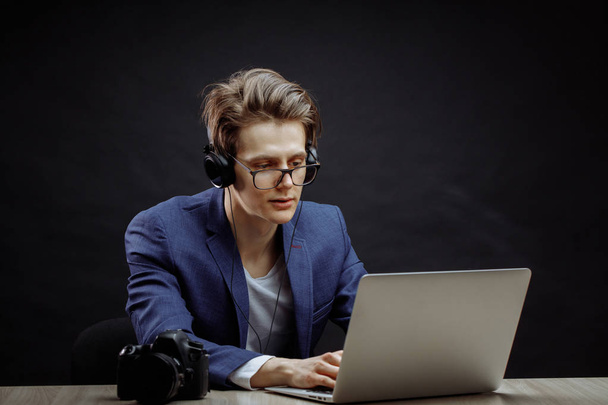 stylish office worker with long brown hair in headphones using the laptop - Foto, immagini