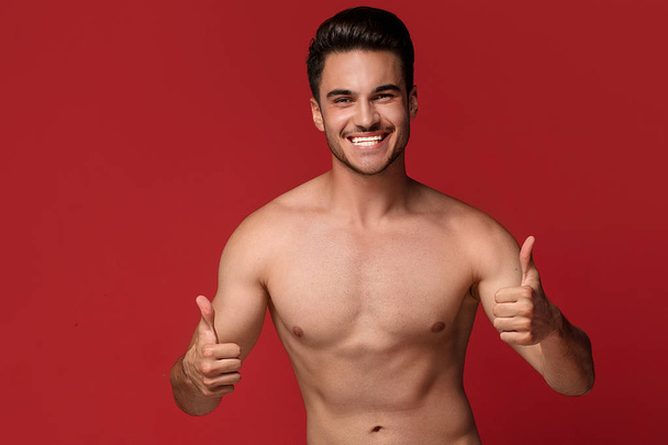 Handsome man with muscular fit body smiling, looking at camera, posing in summer style on colorful studio background. - Fotoğraf, Görsel