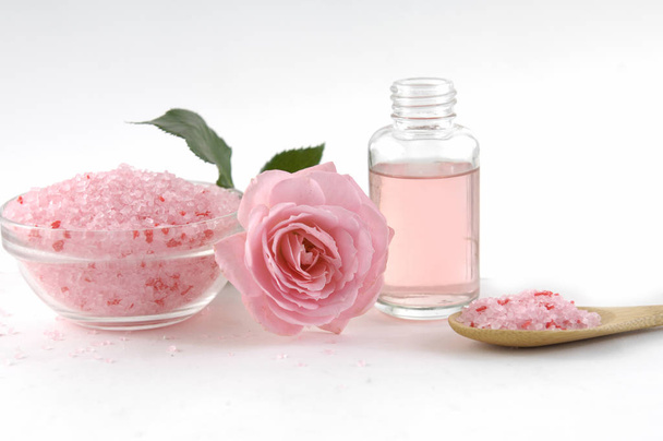 salt in bowl with pink rose,oil on white background - Foto, Imagen