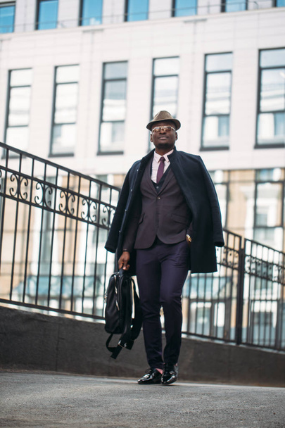dark skinned experienced businessman leaving the workplace - Фото, изображение