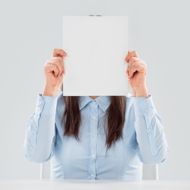 Portrait of business woman holding blank paper sheet - Photo, Image