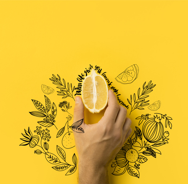 man holding half of lemon isolated on yellow with "when life gives you lemons, make lemonade" lettering and floral illustration - Zdjęcie, obraz