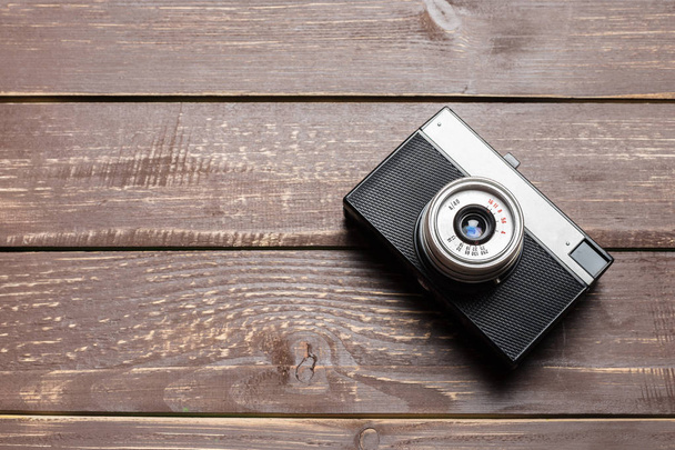 Old retro camera on wooden table background - Photo, image