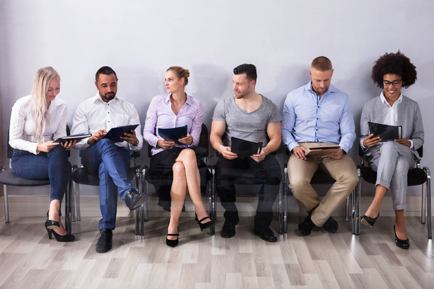 Candidates Sitting In A Row Waiting For Job Interview - Foto, Imagen