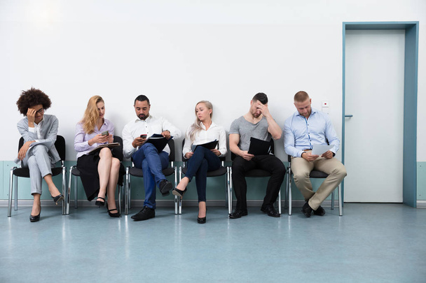 Job Applicants Sitting On Chair For Interview In Office - Photo, image