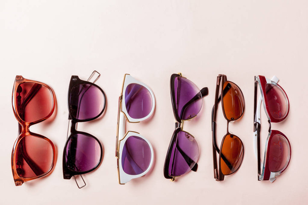 sunglasses on pastel backgrounds. Fashion summer is coming concept. - Foto, Imagem