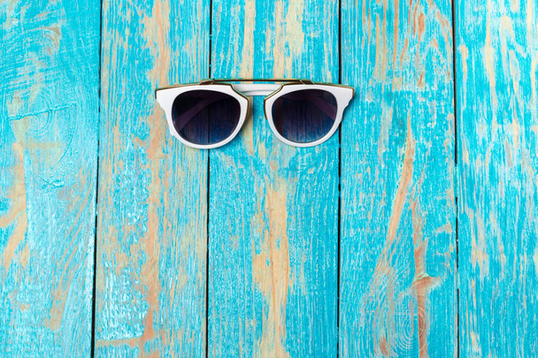 sunglass on the wooden background, close-up view - Fotó, kép