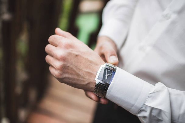 Man in white shirt wearing classic watch, business style concept  - Fotó, kép