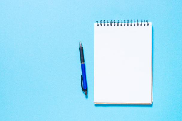 Notebook and pen on blue background. - Photo, Image