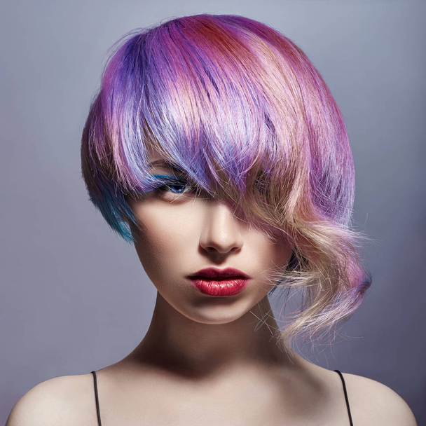 Portrait of a woman with bright colored flying hair, all shades of purple. Hair coloring, beautiful lips and makeup. Hair fluttering in the wind. Sexy girl with short  hair. Professional coloring - Fotoğraf, Görsel