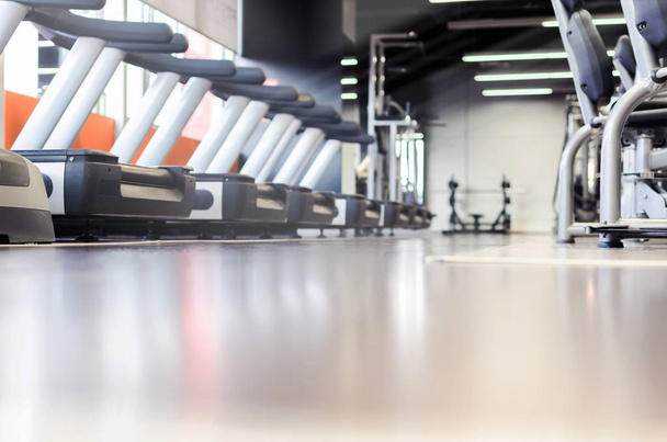 Running equipment in empty gym, space for text - Φωτογραφία, εικόνα