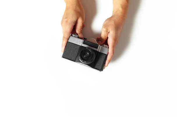 female hands hold vintage camera on white background, close-up view - Valokuva, kuva