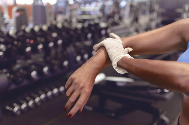 Cropped image of woman's hands, woman getting prepare for workout. - Foto, Bild