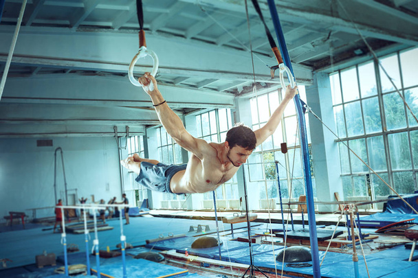 The sportsman during difficult exercise, sports gymnastics - Fotó, kép