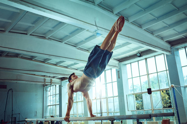 The sportsman during difficult exercise, sports gymnastics - Foto, Imagem