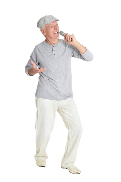 portrait of  senior man singing karaoke  isolated on white background - Fotoğraf, Görsel