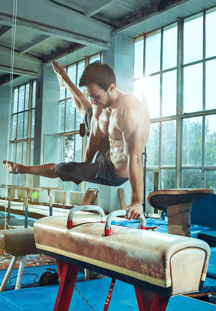 The sportsman during difficult exercise, sports gymnastics - Фото, зображення