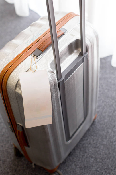 Close up of blank  luggage tag label on a suitcase  - Photo, image