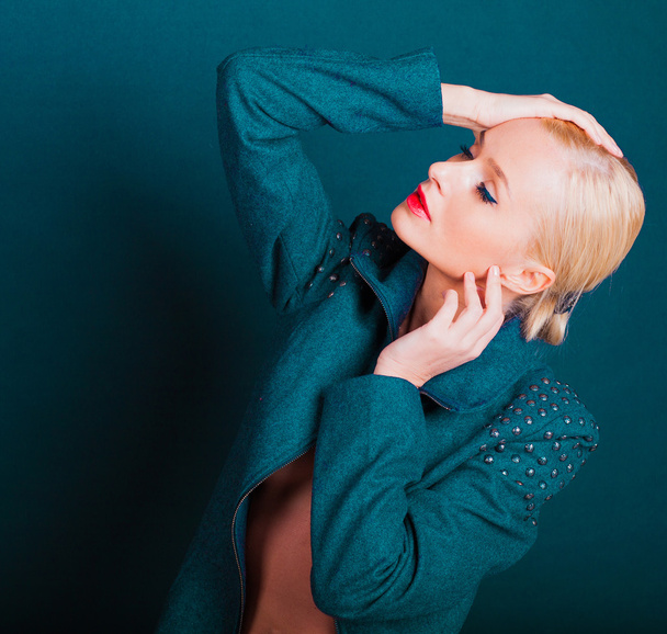 the beautiful fashionable blonde on a gray-blue background - Фото, зображення