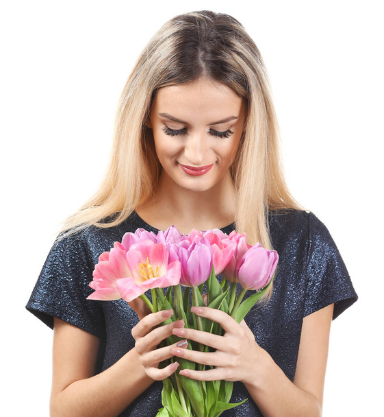 Portrait of beautiful smiling woman with bouquet of tulips on white background - Zdjęcie, obraz