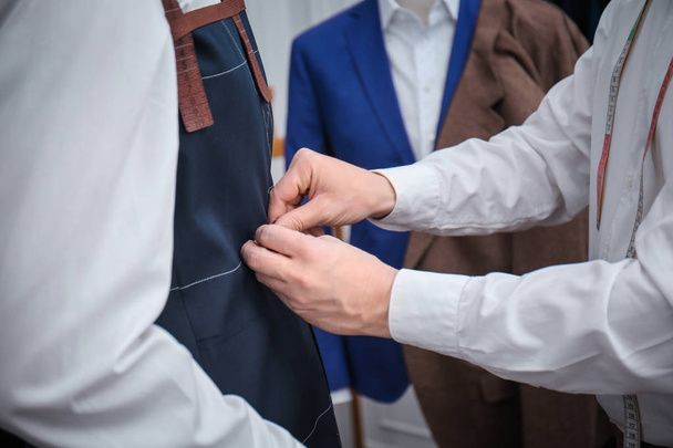 Tailor with client in atelier - 写真・画像