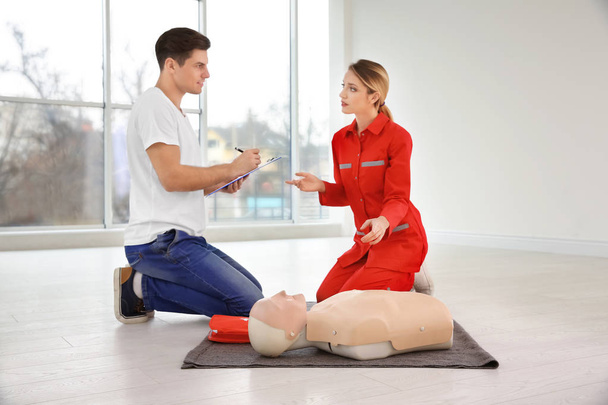 man with instructor in first aid class - Photo, image