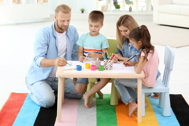 Cute children drawing with parents at home - Photo, Image